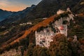 Merano, Italy - Aerial view of the famous Castle Brunnenburg with Tyrol Castle at background in the Italian Dolomites