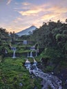 Merapi mountain view from Mangunsuko bridge, Magelang Indonesia. Sunrise with forest scenery, dam and Mountain