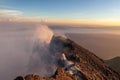 Merapi volcano crater rim with people climbing up.