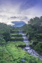 Merapi volcano with lenticular cloud on the peak of mountain with terraced waterfall