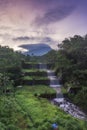 Merapi volcano with lenticular cloud on the peak of mountain with terraced waterfall Royalty Free Stock Photo