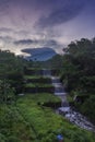 Merapi volcano with lenticular cloud on the peak of mountain with terraced waterfall Royalty Free Stock Photo