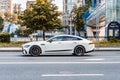 Mercedes-AMG GT 63 S 4-door coupe car on the street. Side view of white Mercedes AMG GT 63 S drive in the city