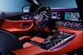 Mercedes-Benz AMG GT car interior with expensive red leather carbon panel monitors and colorful