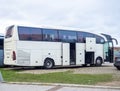 A Mercedes Benz bus is preparing to depart. Loading things onto the bus. Motor transport industry. Open doors