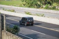 A Mercedes Benz G63 AMG driving fast on trans jawa highway blurry in motion