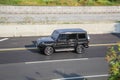 A Mercedes Benz G63 AMG driving fast on trans jawa highway blurry in motion