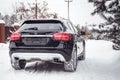 Mercedes Benz GLA 250 on a snow-covered street outside the city.