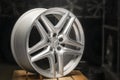 Mercedes Benz logo aluminum cast wheel, close-up, original silver wheel new in black background copyspace, copy space