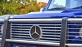 Mercedes Benz logo on blue car SUV . Mercedes-Benz is a German automobile producer. The brand is used for luxury automobiles, buse Royalty Free Stock Photo