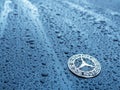 Mercedes benz logo on wet surface