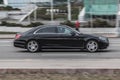 Mercedes-Benz S-class in the city street. Side view of black Mercedes car riding on the road on high speed Royalty Free Stock Photo