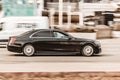 Mercedes-Benz S-class in the city street. Side view of black Mercedes W222 car riding on the road on high speed Royalty Free Stock Photo