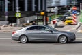 Mercedes-Benz S-class in the city street. Side view of silver Mercedes car riding on the road on high speed