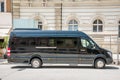 Mercedes Benz sprinter black luxury shuttle bus van parked on the street