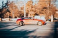 Mercedes E-Class C238 coupe on the city road. Fast moving shiny red car on Moscow streets. Premium Mercedes-Benz E 300 Sport side