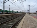 Merchandise train station. View of train tracks with rails and freight wagons with power lines Royalty Free Stock Photo