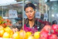 Merchandiser setting out goods in greengrocer