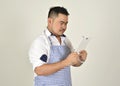 Merchant Asian fat man in white and blue apron is use technology read data news from connection internet in tablet