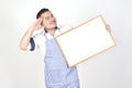 Merchant Asian man in white and blue apron to holding blank white broad for put some text or wording for present advertising