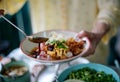 Merchant cook soy sauce on top of delicious Chinese steamed rice noodle rolls.