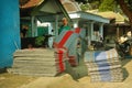 Merchant holding pile of traditional carpet