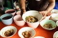 Women`s hands show delicious noodle bowl