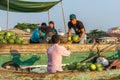 A merchant sells watermelons to a reseller at Cai Rang floating
