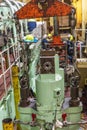 Merchant ship's engine room during main engine maintenance, dismounted cylinder head with exhaust valve on the first plan. Royalty Free Stock Photo