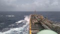 A merchant ship underway at sea in rough weather