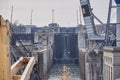 Merchant ship vessel with two cranes passing locks in the Great Lakes, Canada in winter time.