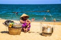 Merchants sell local food to tourists on a beach