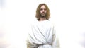 Merciful Jesus looking into camera against shining background, grace of Lord Royalty Free Stock Photo