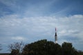 Mercury Redstone rocket pointing above trees towards sky