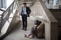 Mercy Businessman look at Homeless in city