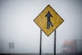 Merge sign barely seen through winter storm