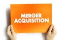 Merger Acquisition - involves the process of combining two companies into one, text concept on card Royalty Free Stock Photo