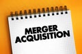 Merger Acquisition - involves the process of combining two companies into one, text concept on notepad Royalty Free Stock Photo