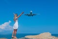 Merging Horizons: Girl in White Dress on Stones, Meeting of Sea and Sky Royalty Free Stock Photo