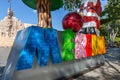 Merida, Mexico - 11 February, 2020: Big colorful letters representing Merida with an iconic Homeland Monument Monumento a la