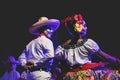 Close up of a Catrina couple at public dance performance with traditional Mexican costumes in Merida, Mexico