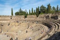 Tourists visiting the Roman ruins theatre arena & waiting rooms used for gladiator & animal fights in Merida, Spain