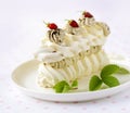 Meringue cake with fresh berries on white background