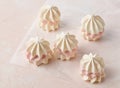 Meringue cakes on pink background