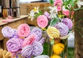 Meringue cakes on stick assortment on banquet table.