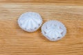 Meringue cookies in ruffled paper molds on the wooden surface Royalty Free Stock Photo