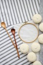 Meringue homemade zephyr marshmallows with round embroidery hoop frame and wooden spoons on cotton tablecloth. Mockup card.