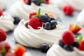 Meringue nest mini pavlova cake with fresh berries strawberry blueberry raspberry and mint for healthy desert Royalty Free Stock Photo