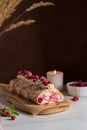 Meringue roll cake with berries whipped cream and Coffe over a dark background. Summer dessert. Dark photo. Royalty Free Stock Photo