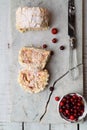 Meringue roll cake, fresh cranberries on creacked marble board, top view Royalty Free Stock Photo